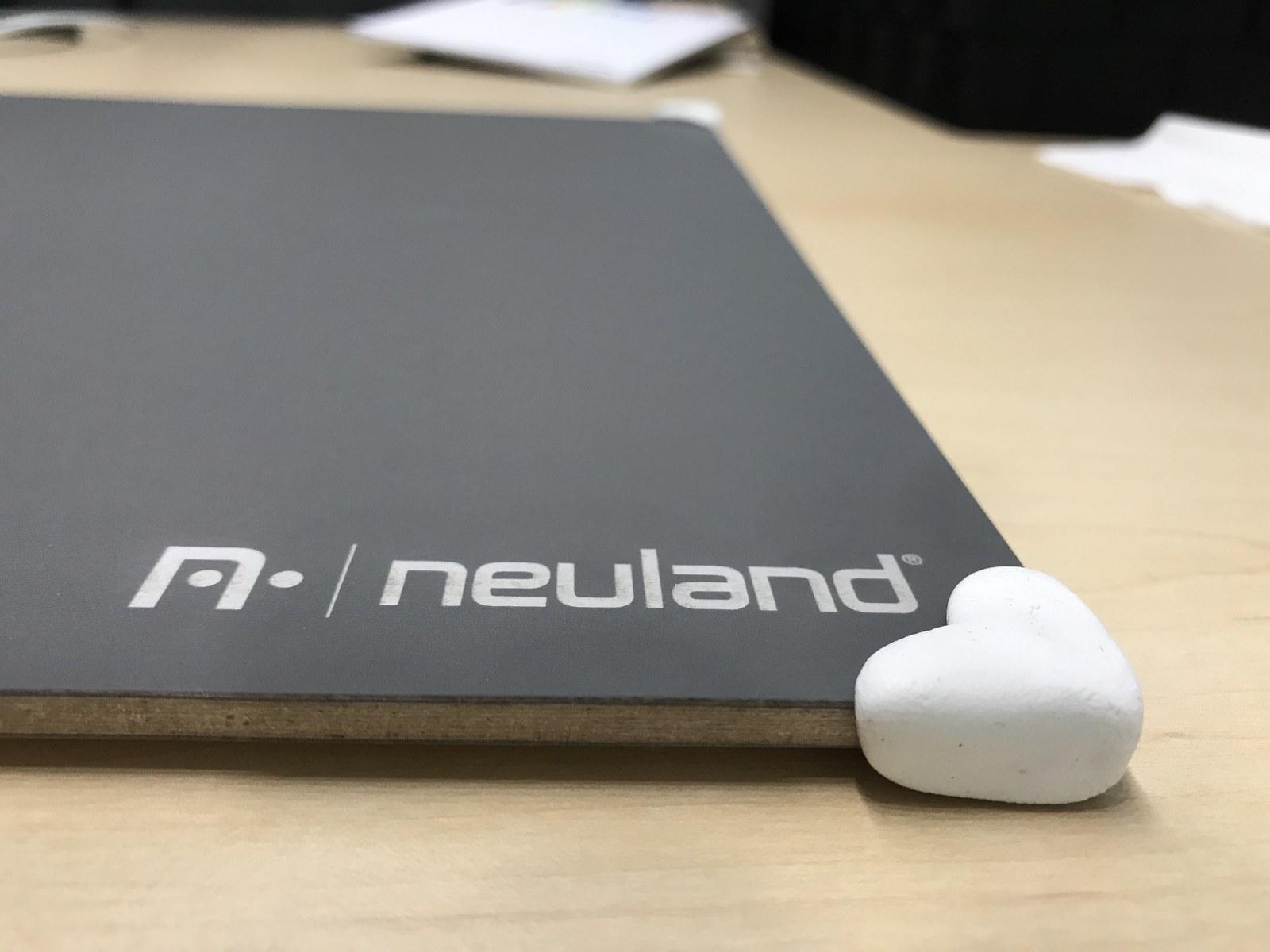 Close-up of a rounded white Sugru corner covering the edge of the myWorkBoard WB