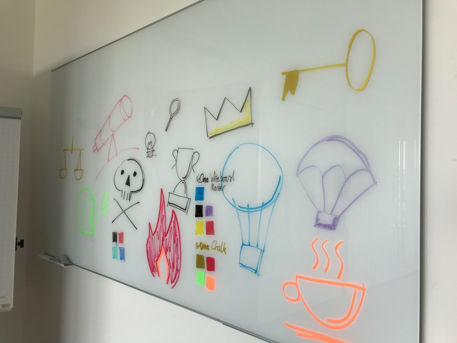 Colored icons, strokes and swatches drawn on a glass board.