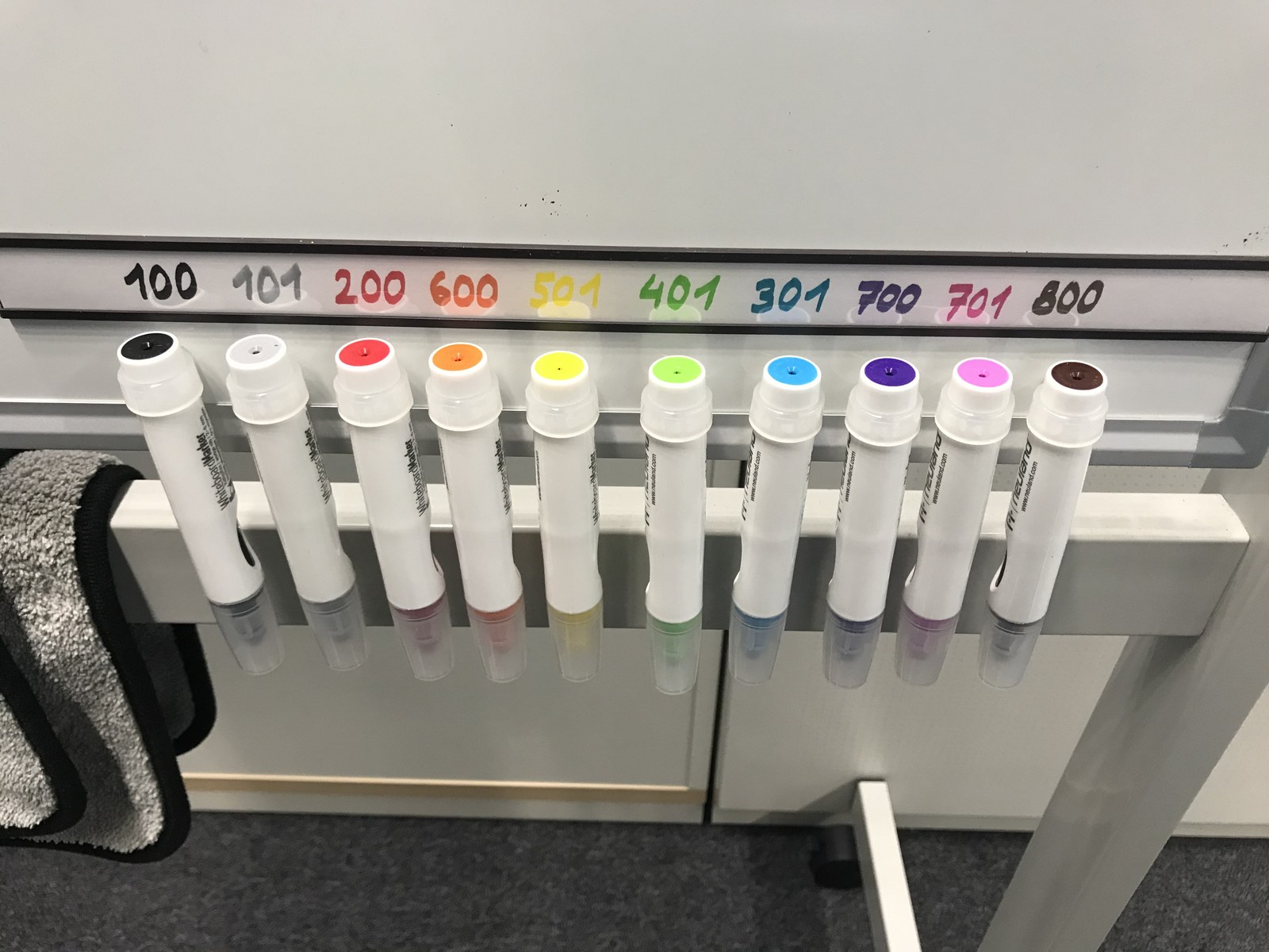Ten markers hanging beneath a strip of matching color-number labels.